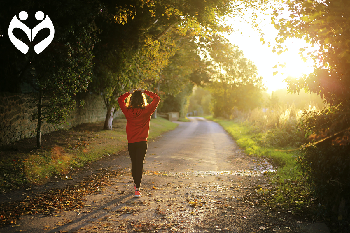 girl looking toward sun on a road