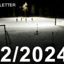 far away shot of people playing hockey on a community rink at night.