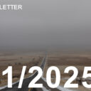 lone highway in the winter, with clouds obscuring the horizon and snow on the edges of the road.