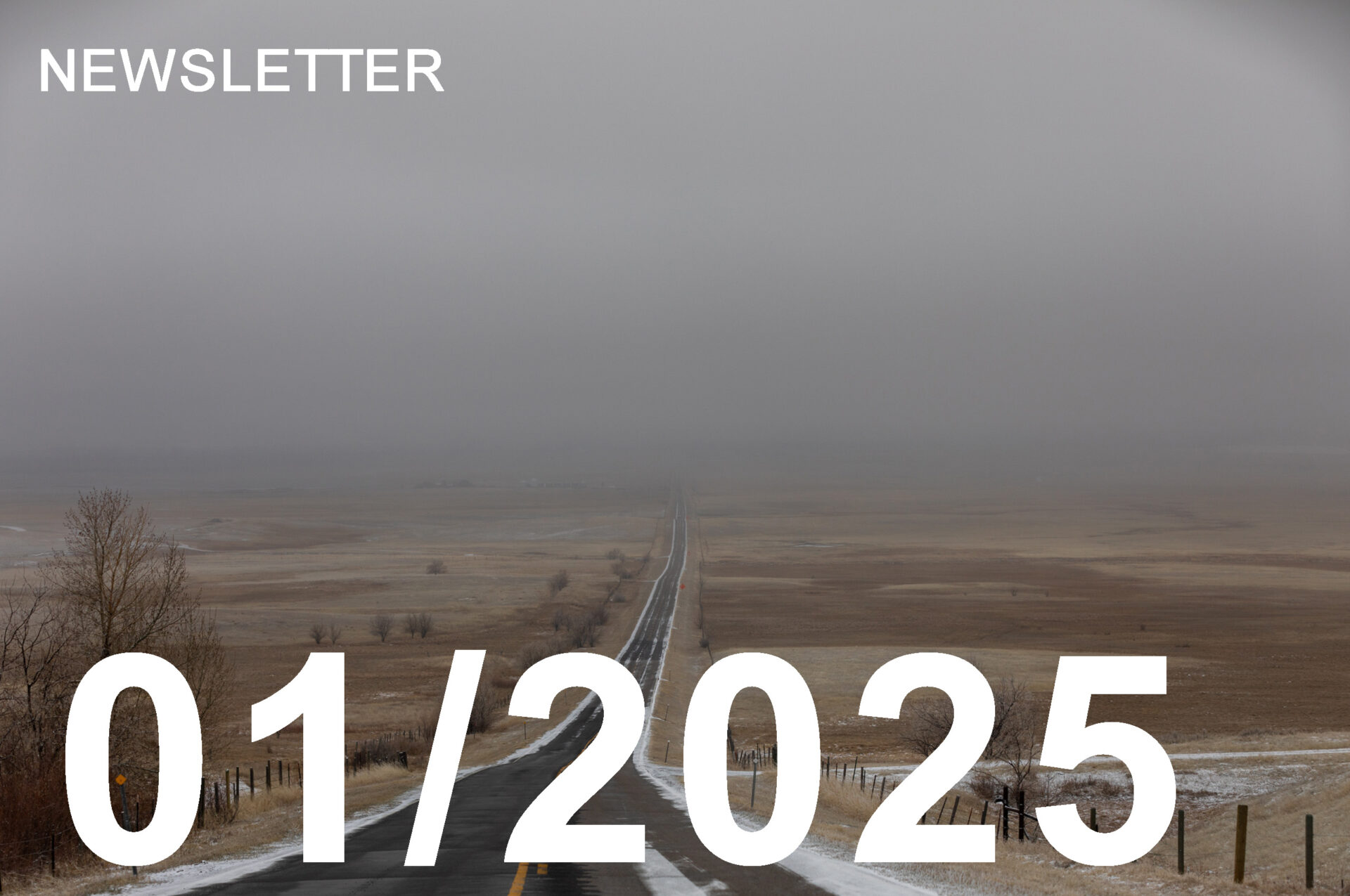 lone highway in the winter, with clouds obscuring the horizon and snow on the edges of the road.